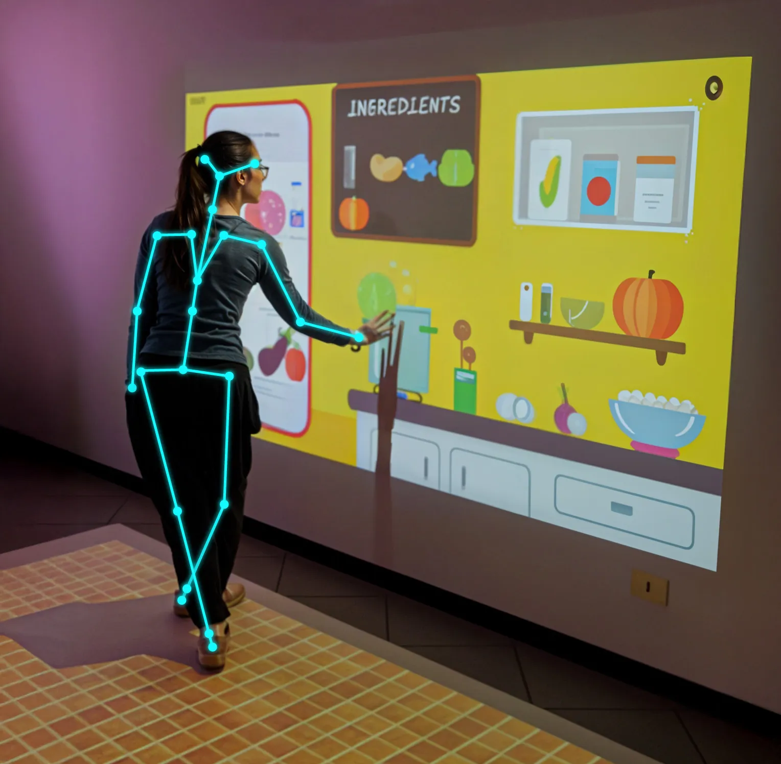 A patient exercising with an interactive wall projection that tracks her movement